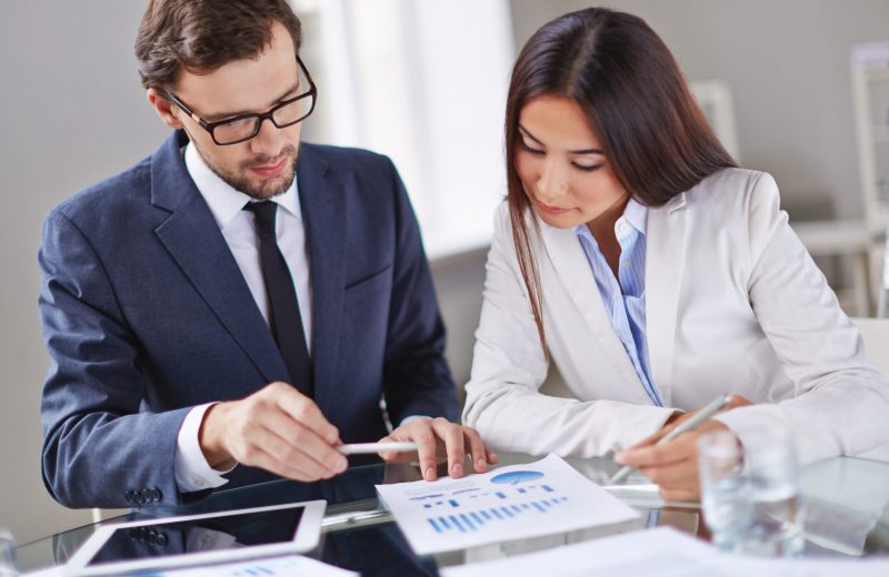 Portrait of smart businesswoman and businessman working in office