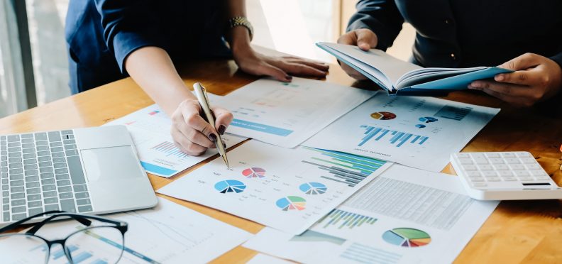financial advisory services. Group of business advisor showing plan of investment to clients in the consultancy office.